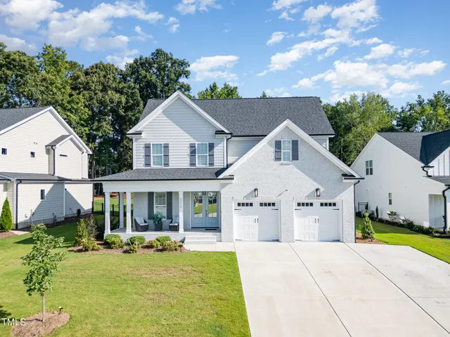 a view of house with yard outdoor seating and barbeque oven
