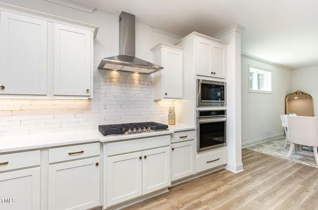a kitchen with cabinets and appliances