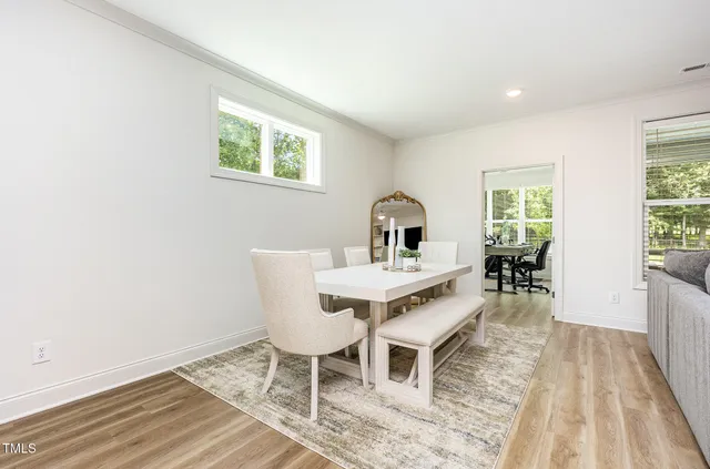 a view of a dining room with furniture and wooden floor