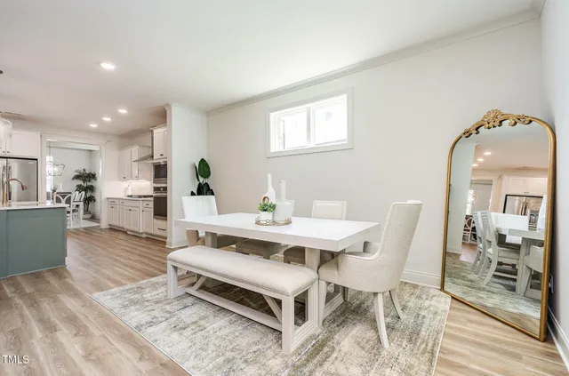a living room with furniture a dining table and kitchen view
