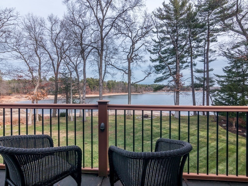 128 Locksley Road Lynnfield, MA 01940 - Photo 1 of 38 a view of roof deck with large trees and wooden fence