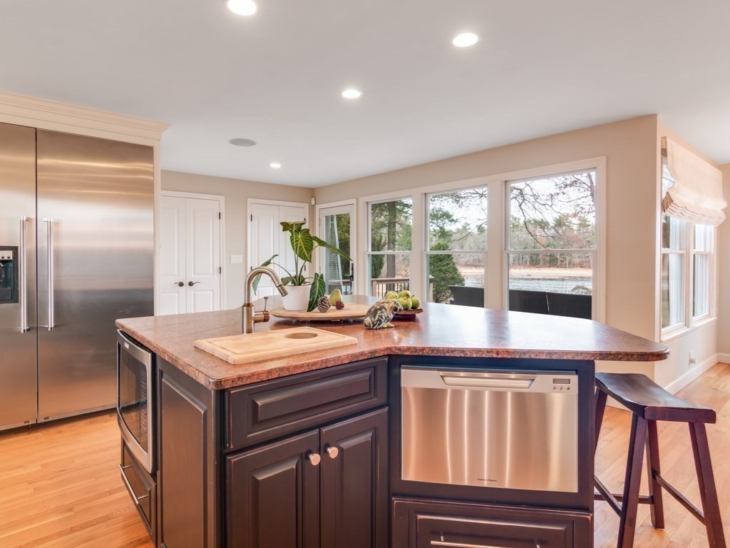 128 Locksley Road Lynnfield, MA 01940 - Photo 11 of 38 a kitchen with a stove a refrigerator a sink and wooden cabinets