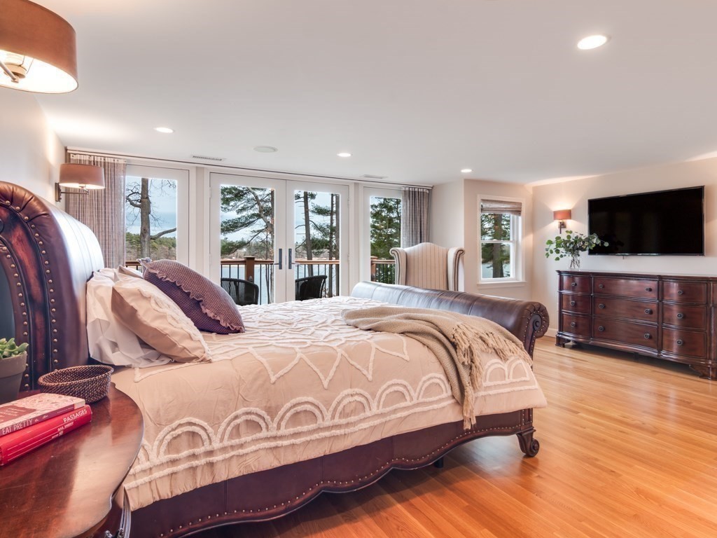 128 Locksley Road Lynnfield, MA 01940 - Photo 18 of 38 a bedroom with a large bed and a flat screen tv
