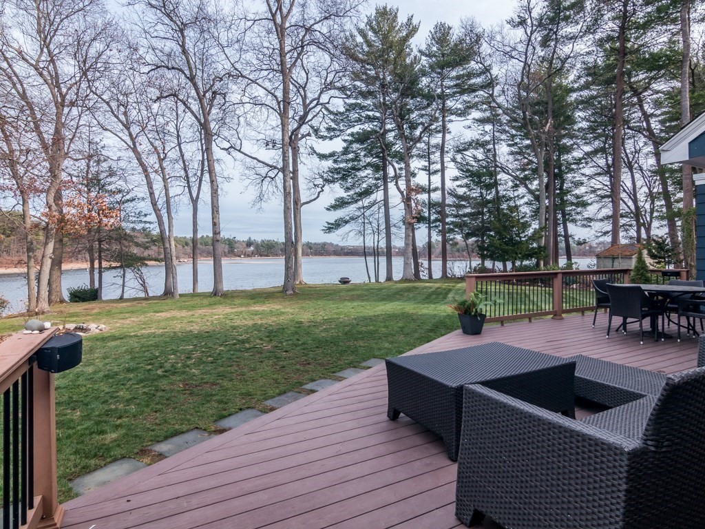 128 Locksley Road Lynnfield, MA 01940 - Photo 28 of 38 a view of a swimming pool with chairs and table on the wooden deck