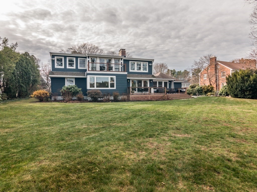 128 Locksley Road Lynnfield, MA 01940 - Photo 33 of 38 a view of a house with a big yard and large trees