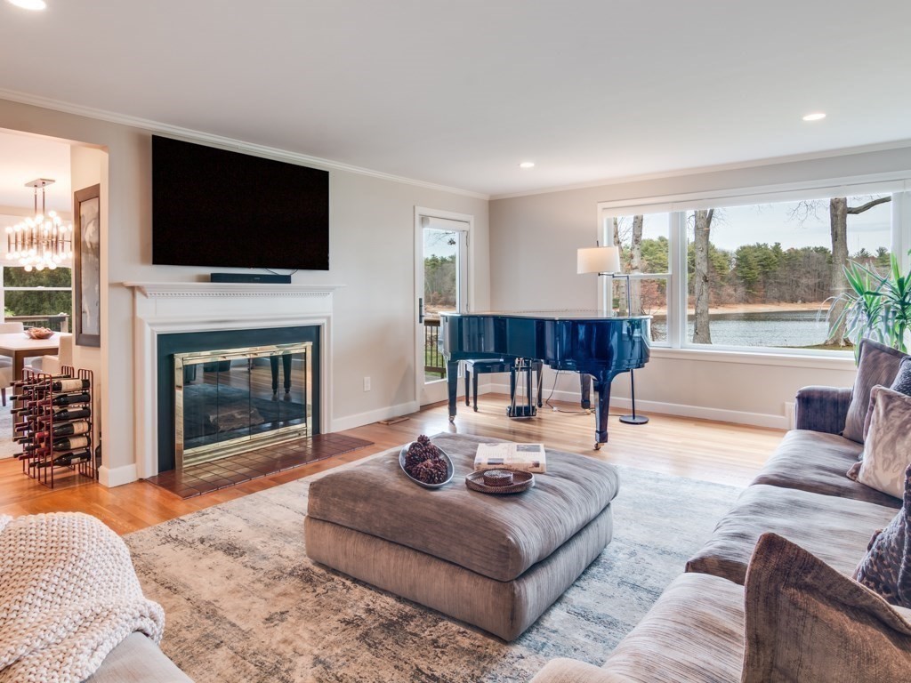 128 Locksley Road Lynnfield, MA 01940 - Photo 5 of 38 a living room with furniture a fireplace and a flat screen tv