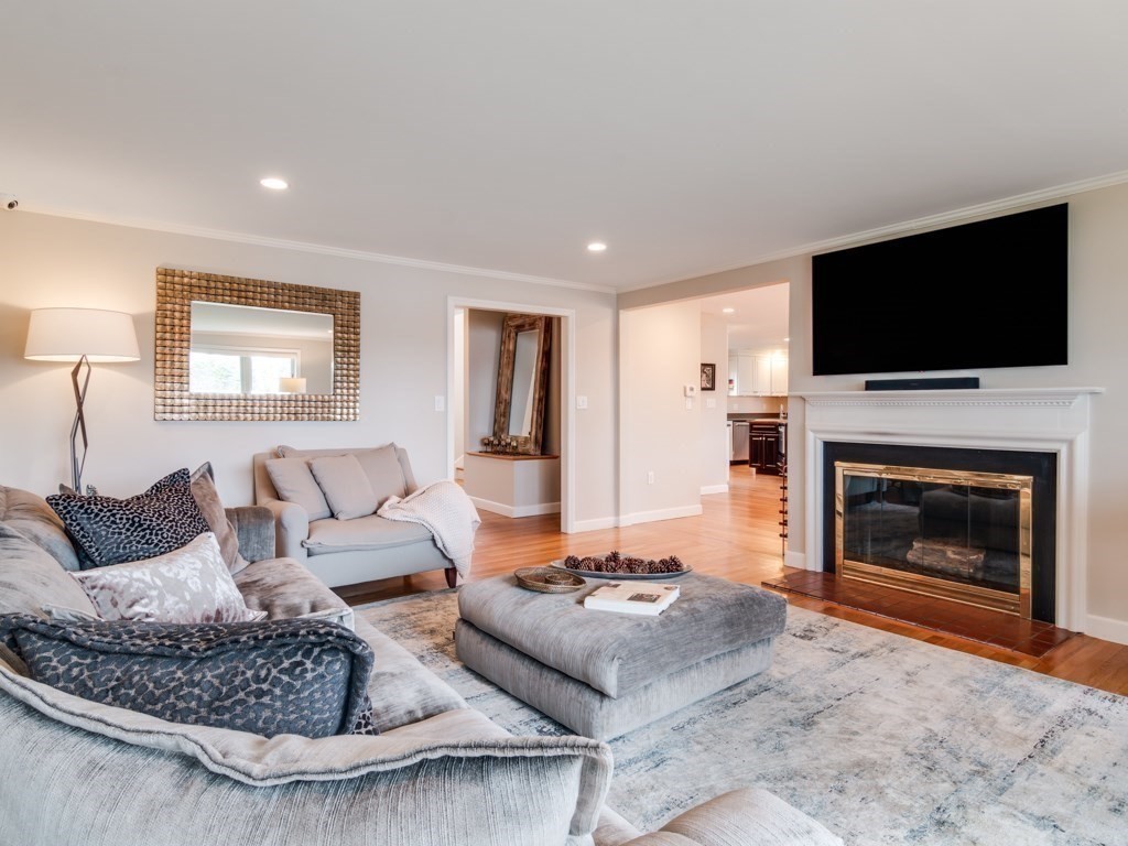 128 Locksley Road Lynnfield, MA 01940 - Photo 6 of 38 a living room with furniture a flat screen tv and a fireplace