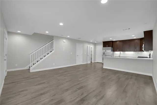 a kitchen with kitchen island a counter top space cabinets and stainless steel appliances
