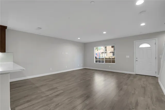 a view of an empty room with a kitchen