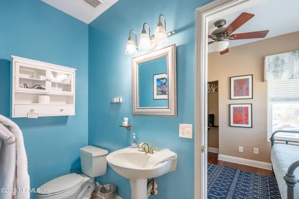 a bathroom with a shower a sink and a mirror