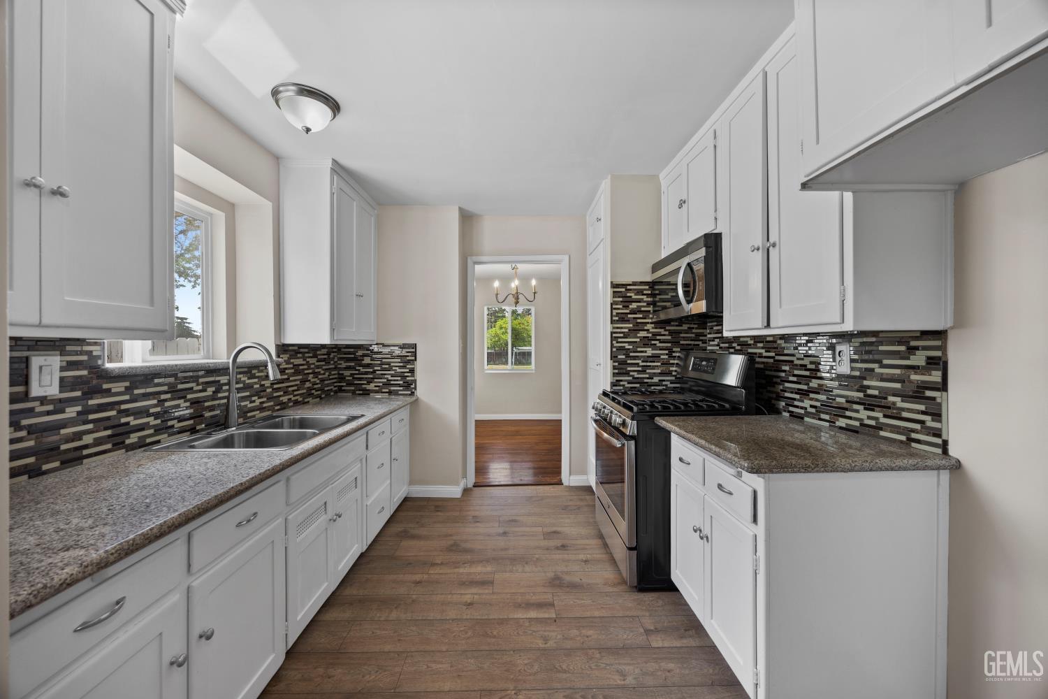 Undisclosed Address Bakersfield, CA 93305 - Photo 11 of 29 a kitchen with stainless steel appliances granite countertop a stove and a sink