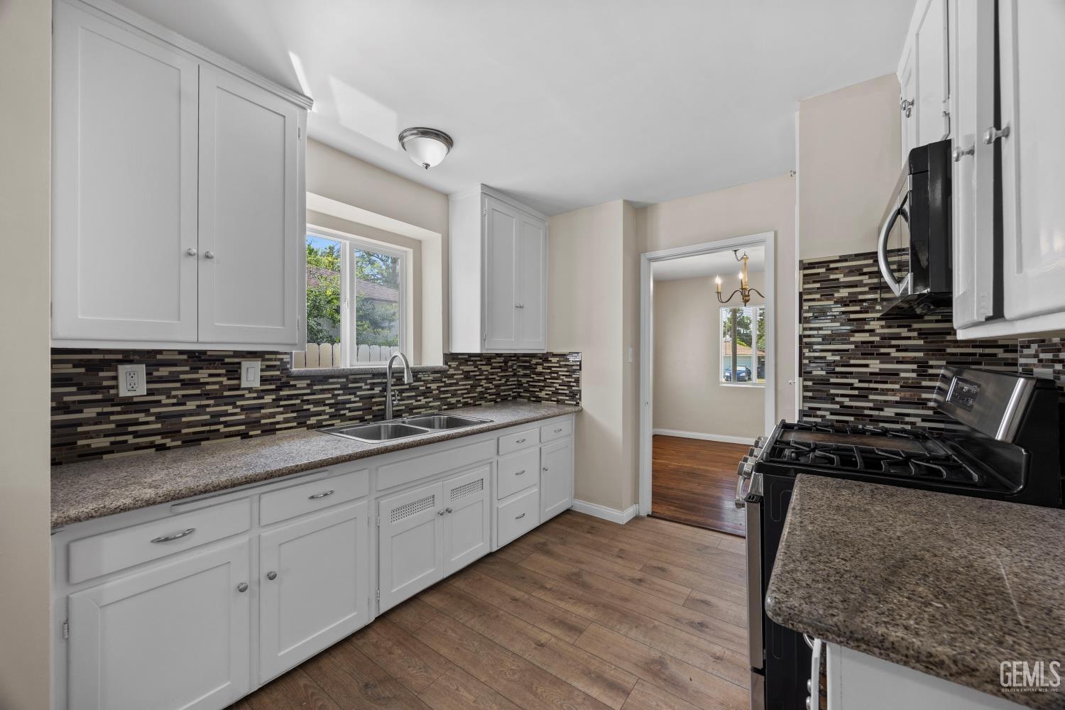 Undisclosed Address Bakersfield, CA 93305 - Photo 12 of 29 a bathroom with a granite countertop sink a toilet and mirror