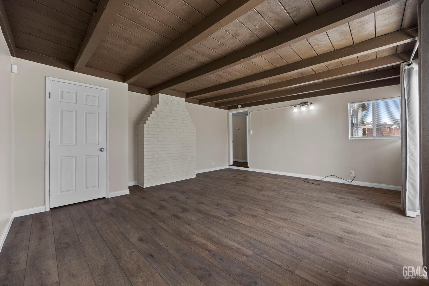 Undisclosed Address Bakersfield, CA 93305 - Photo 14 of 29 a view of empty room with wooden floor and fan