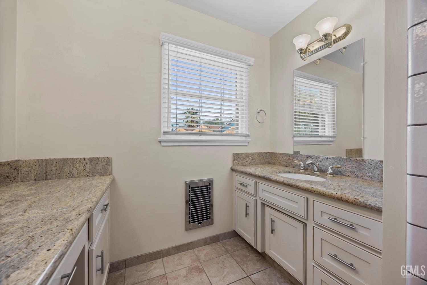 Undisclosed Address Bakersfield, CA 93305 - Photo 17 of 29 a spacious bathroom with a granite countertop sink a mirror and a bathtub