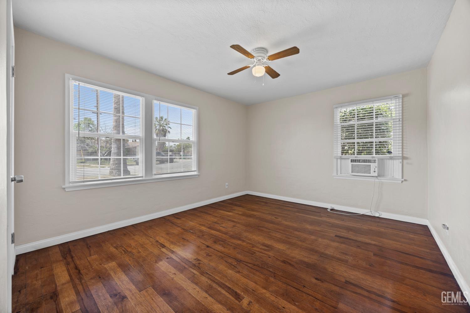 Undisclosed Address Bakersfield, CA 93305 - Photo 18 of 29 a view of an empty room with wooden floor and a window