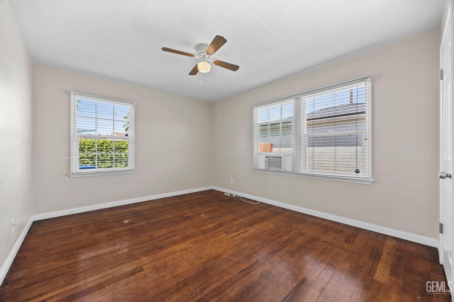 Undisclosed Address Bakersfield, CA 93305 - Photo 20 of 29 a view of an empty room with wooden floor and a window