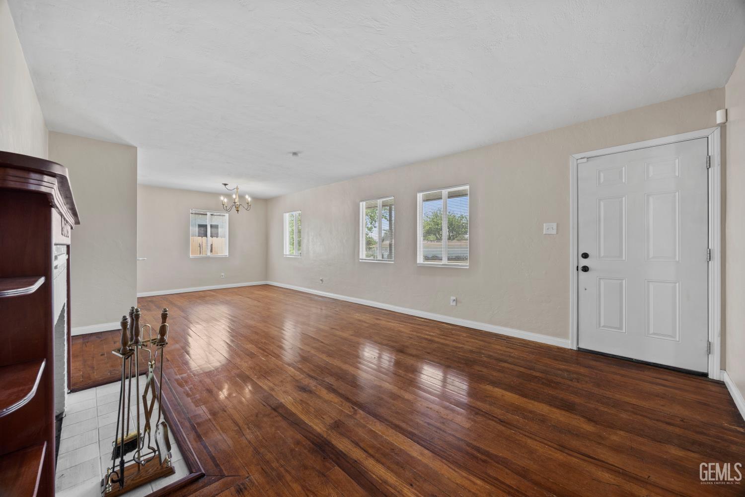 Undisclosed Address Bakersfield, CA 93305 - Photo 5 of 29 a view of a room with wooden floor windows and ceiling fan