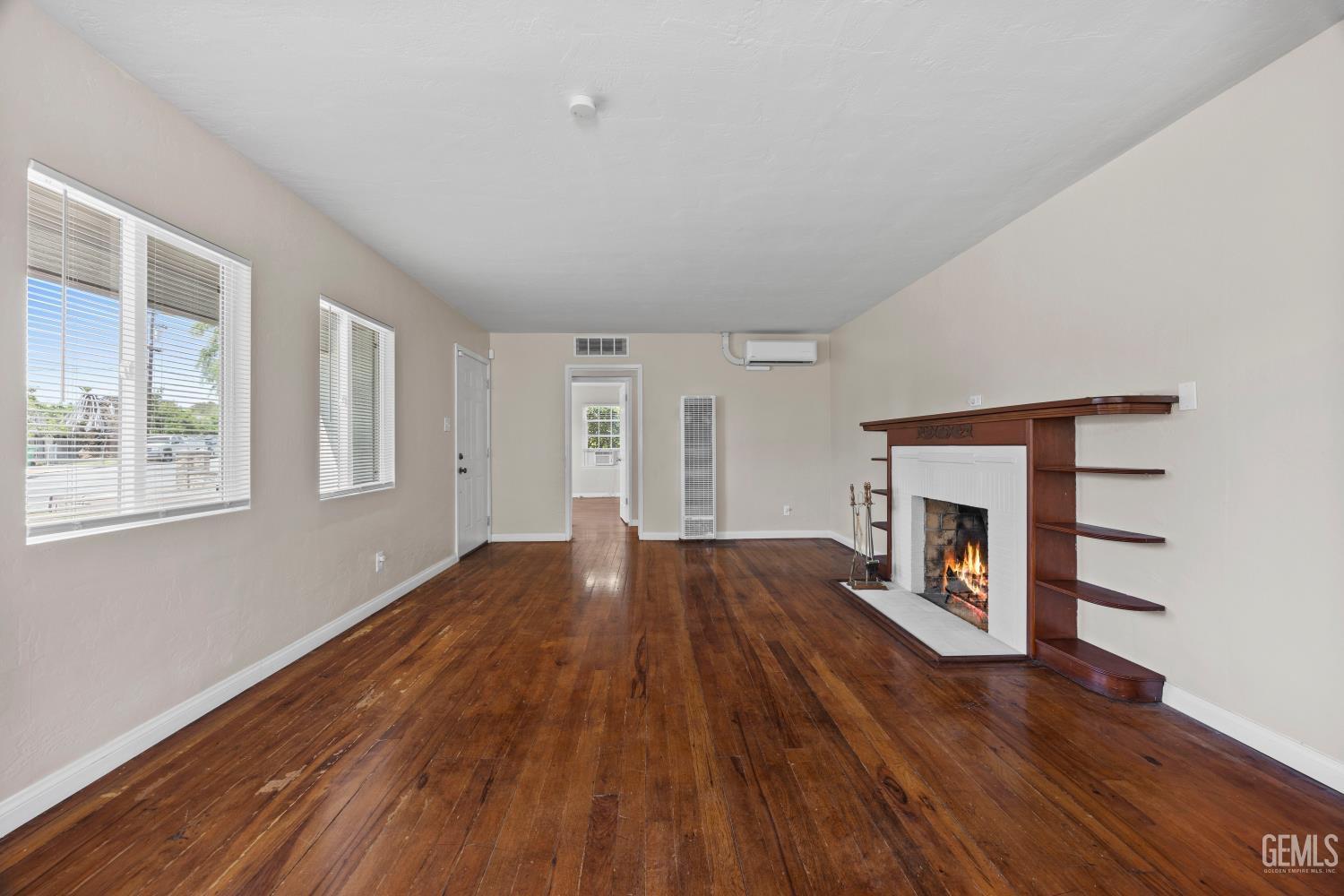 Undisclosed Address Bakersfield, CA 93305 - Photo 7 of 29 wooden floor fireplace and windows in an empty room