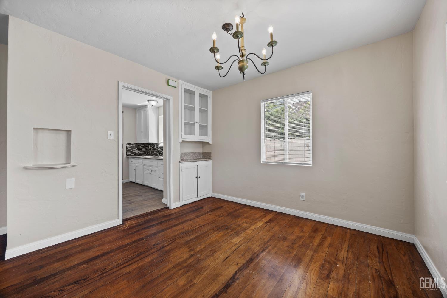 Undisclosed Address Bakersfield, CA 93305 - Photo 8 of 29 a view of empty room with wooden floor