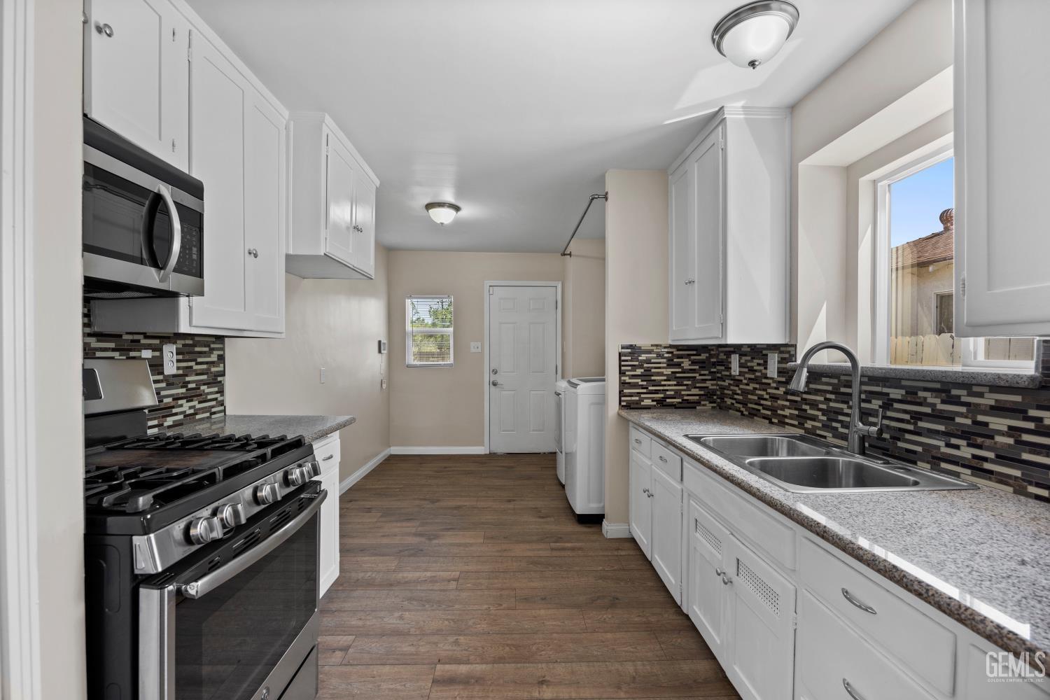 Undisclosed Address Bakersfield, CA 93305 - Photo 10 of 29 a kitchen with stainless steel appliances a sink stove and cabinets