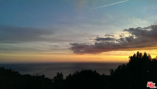 a utility room with a glass door and shower