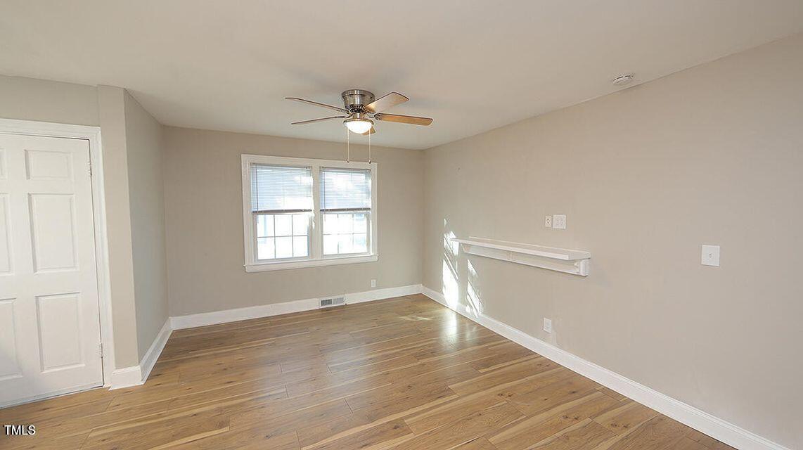 615 Arnette Avenue Durham, NC 27701 - Photo 3 of 13 a view of empty room with wooden floor and fan