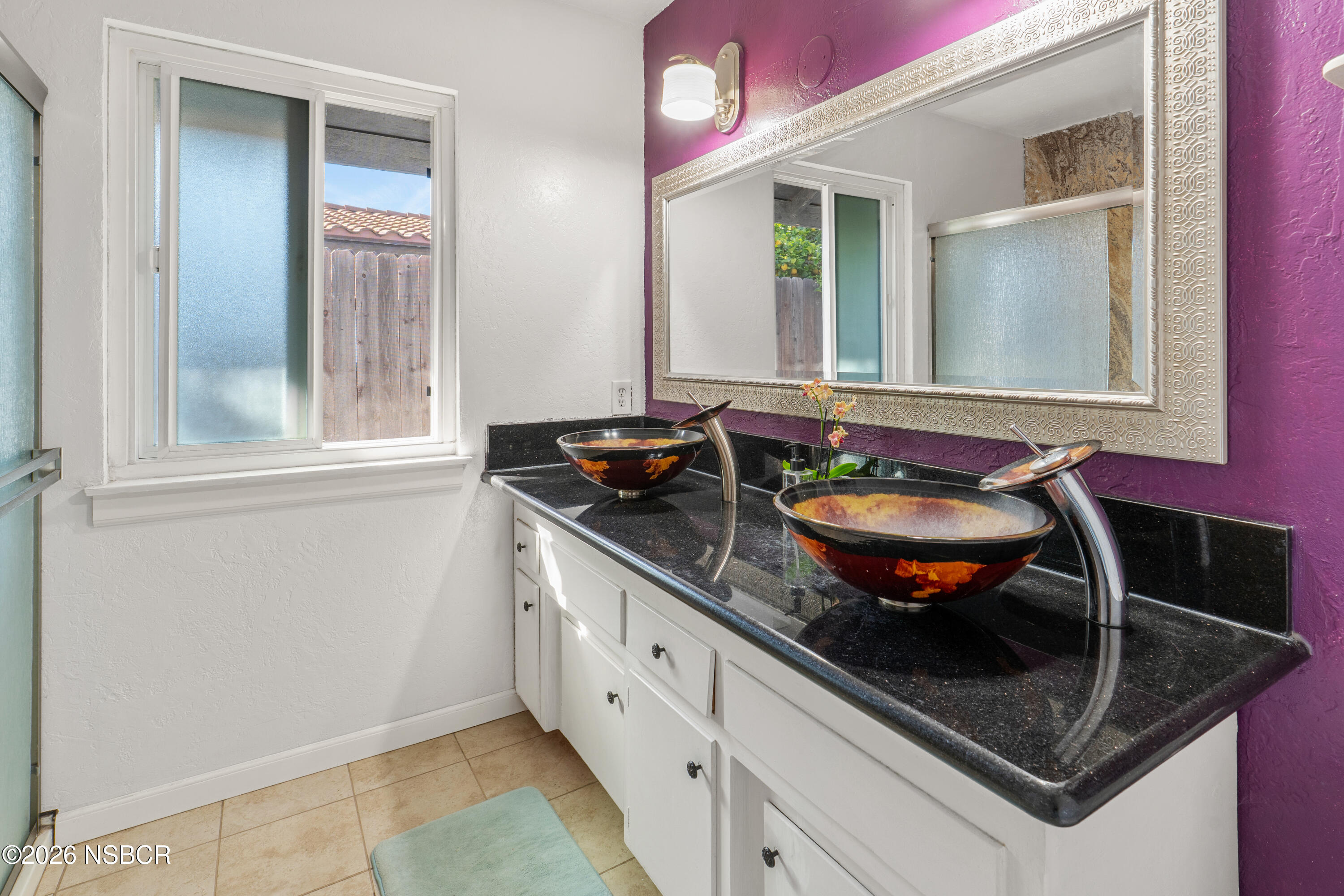 4220 Constellation Road Lompoc, CA 93436 - Photo 13 of 22 a bathroom with a granite countertop sink a mirror and window