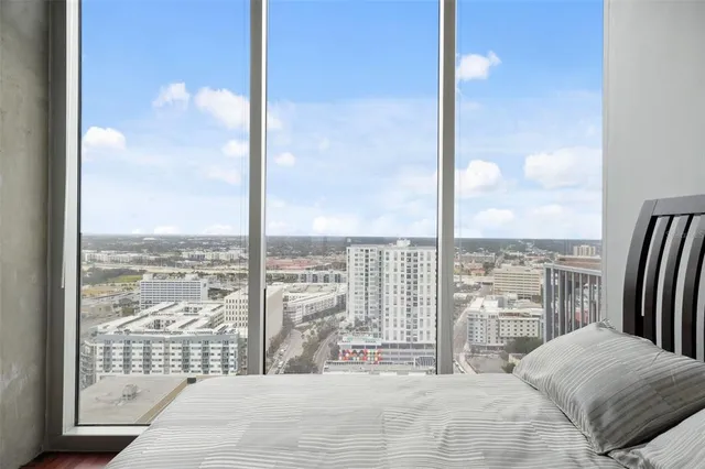 a en suite bathroom with a granite countertop sink and a large mirror