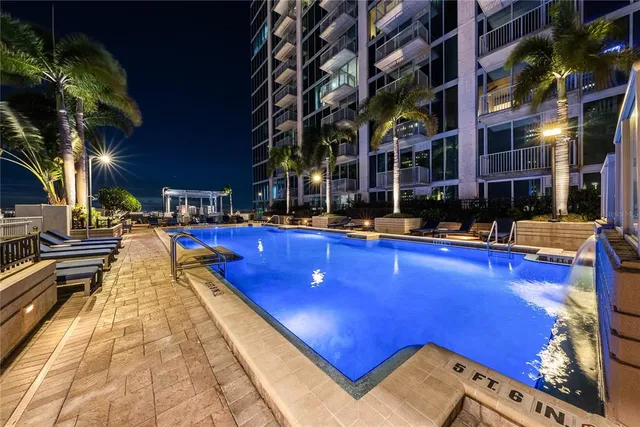 a view of the house with swimming pool and sitting area