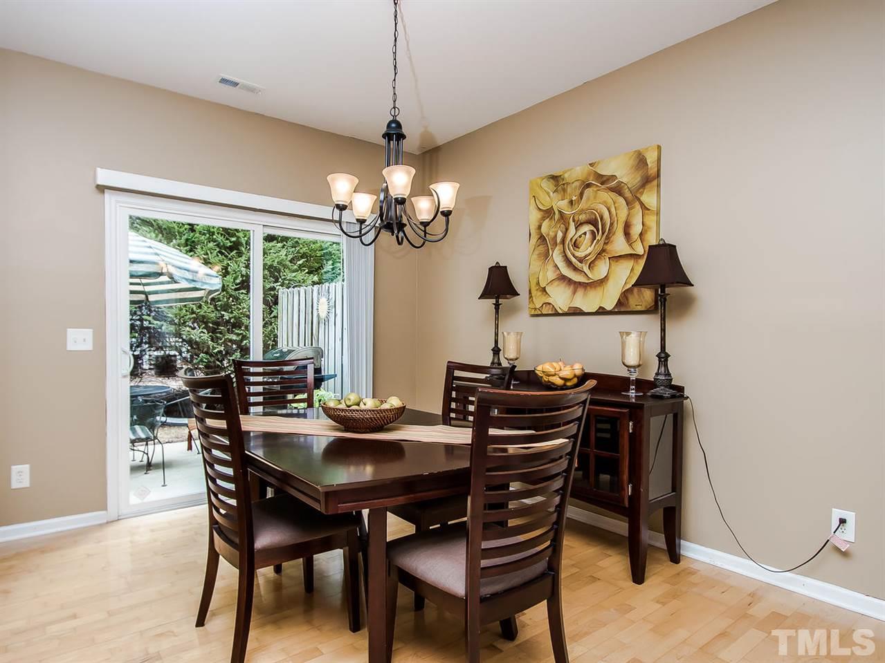 8514 Bright Loop Raleigh, NC 27613 - Photo 11 of 20 a view of a dining room with furniture wooden floor and chandelier