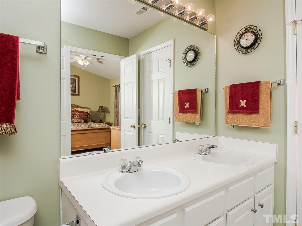 8514 Bright Loop Raleigh, NC 27613 - Photo 14 of 20 a bathroom with a sink and a mirror