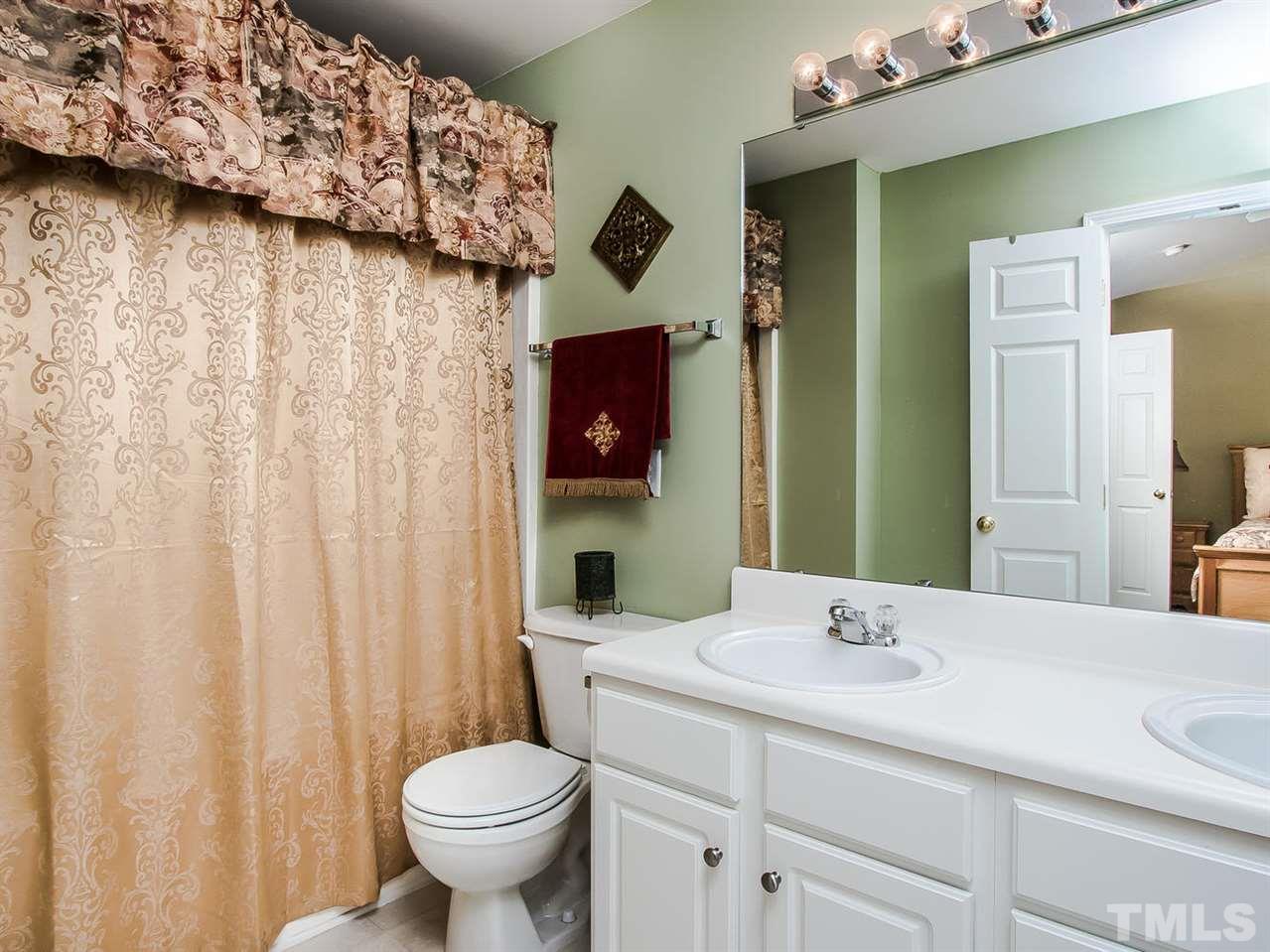 8514 Bright Loop Raleigh, NC 27613 - Photo 15 of 20 a bathroom with a toilet sink and mirror