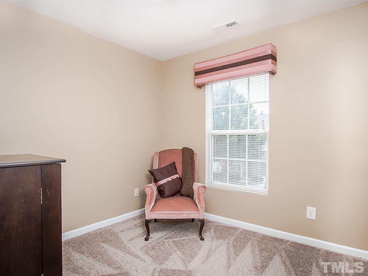8514 Bright Loop Raleigh, NC 27613 - Photo 18 of 20 a room with chair and a window