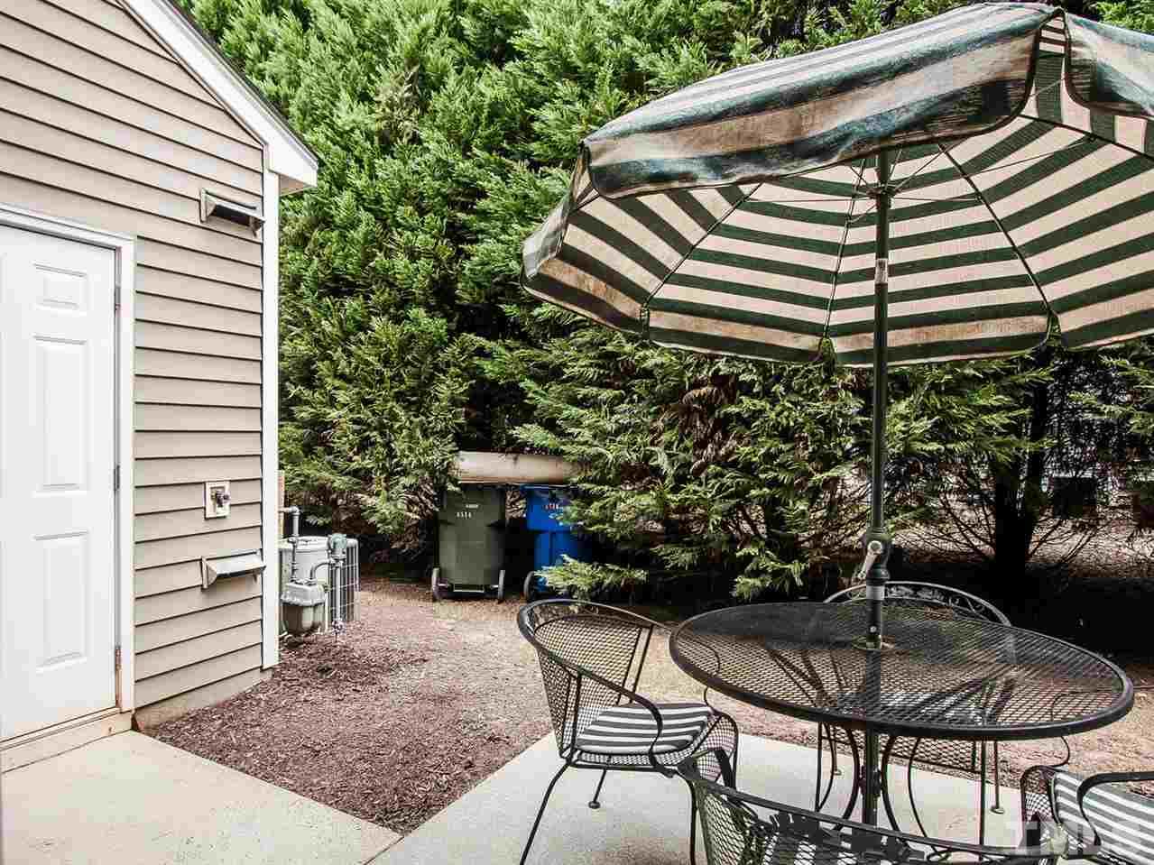 8514 Bright Loop Raleigh, NC 27613 - Photo 20 of 20 a backyard of a house with table and chairs