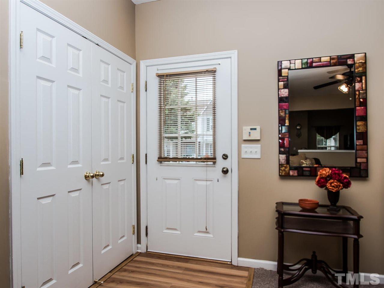 8514 Bright Loop Raleigh, NC 27613 - Photo 3 of 20 a view of a livingroom with wooden floor and windows