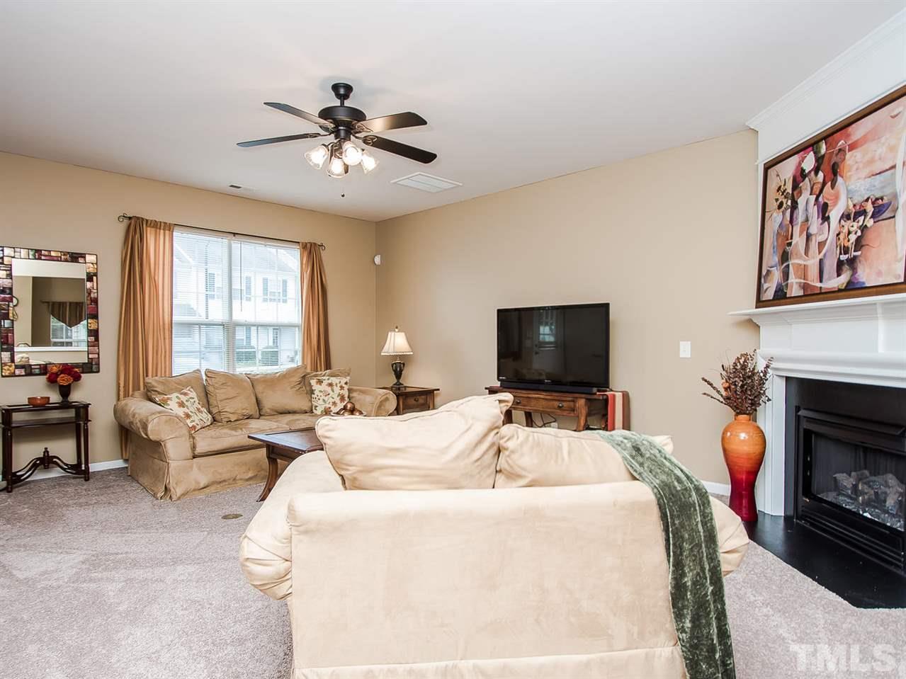 8514 Bright Loop Raleigh, NC 27613 - Photo 5 of 20 a bedroom with a bed and a fireplace