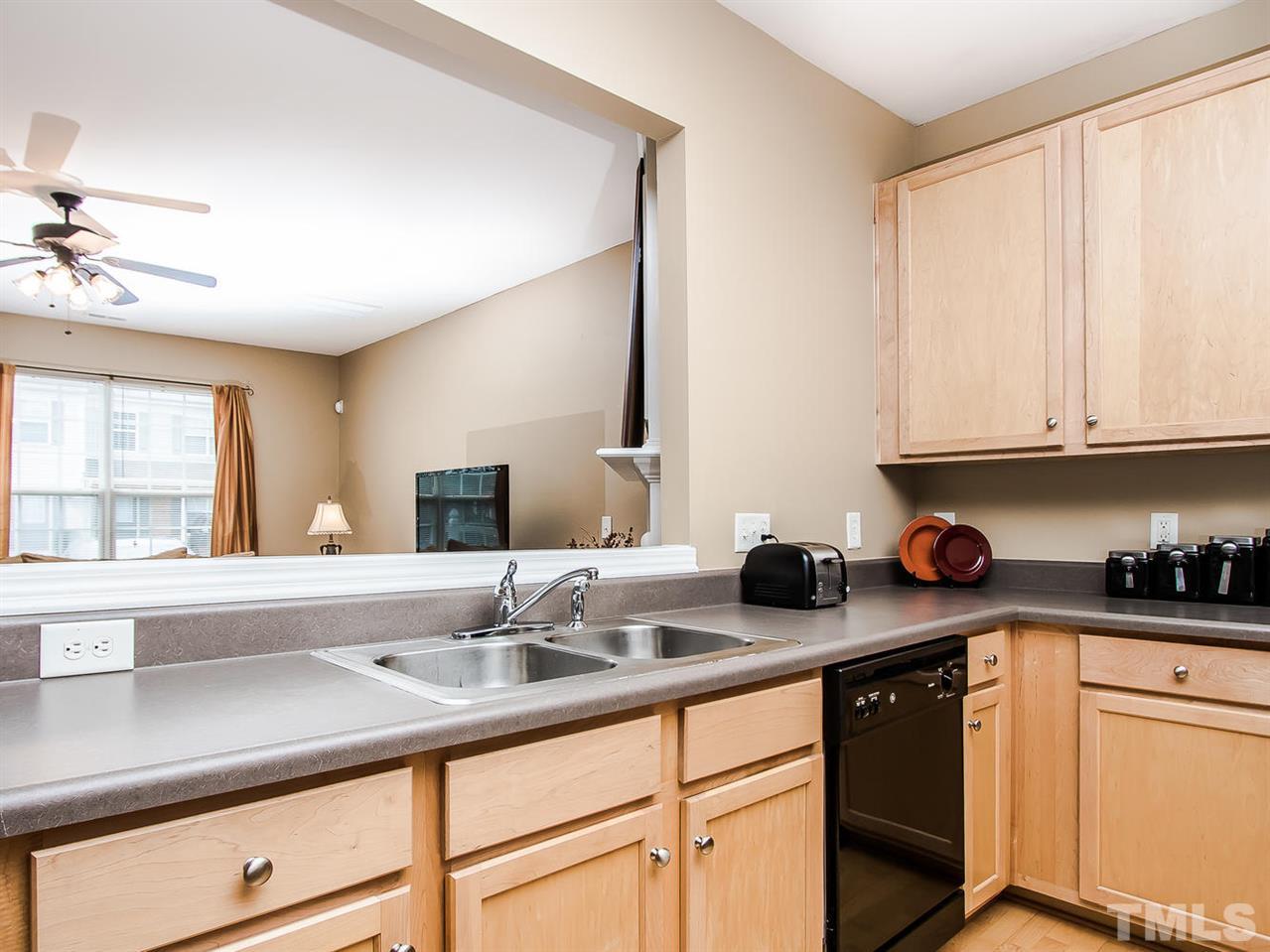 8514 Bright Loop Raleigh, NC 27613 - Photo 8 of 20 a kitchen with sink cabinets and window