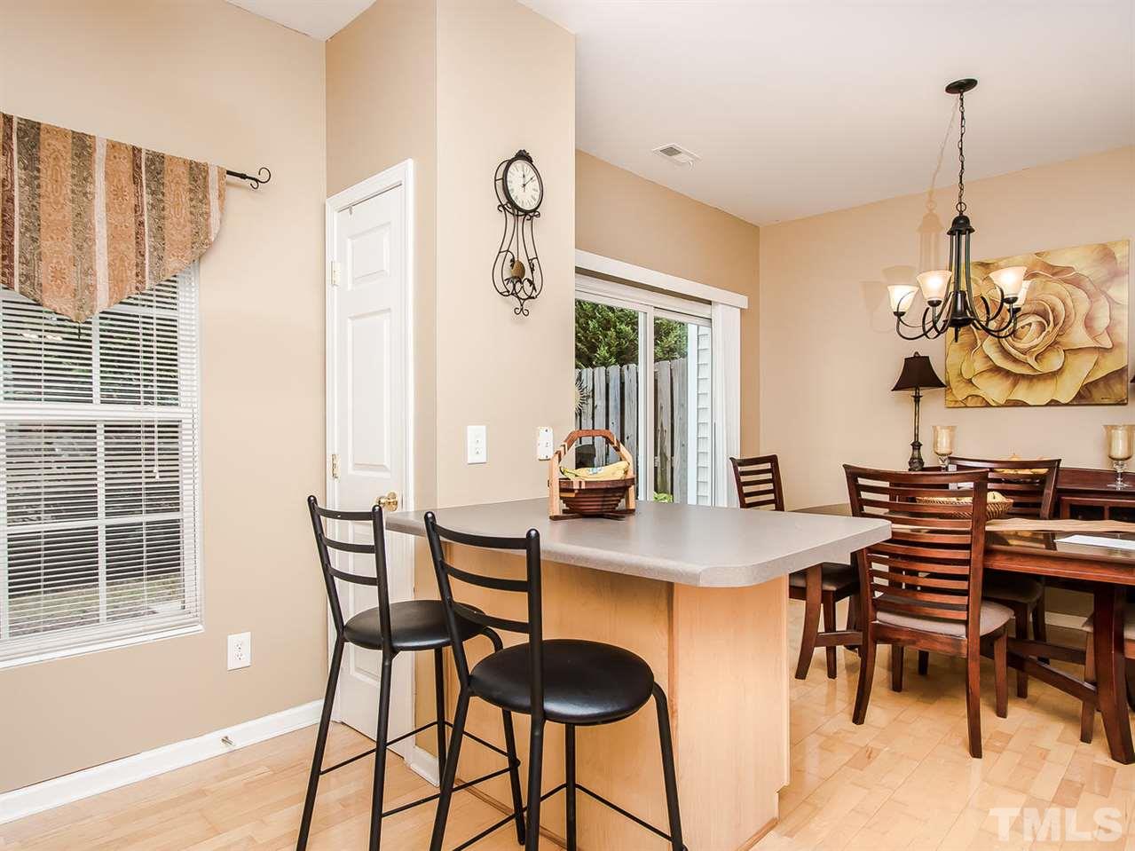 8514 Bright Loop Raleigh, NC 27613 - Photo 10 of 20 a view of a dining room with furniture and window