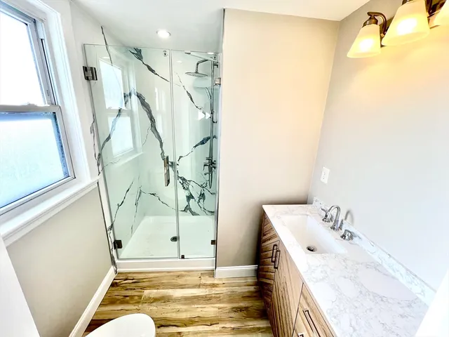 a bathroom with a tub sink and mirror