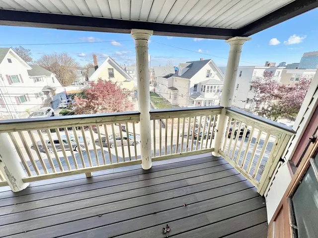 a view of wooden balcony with furniture
