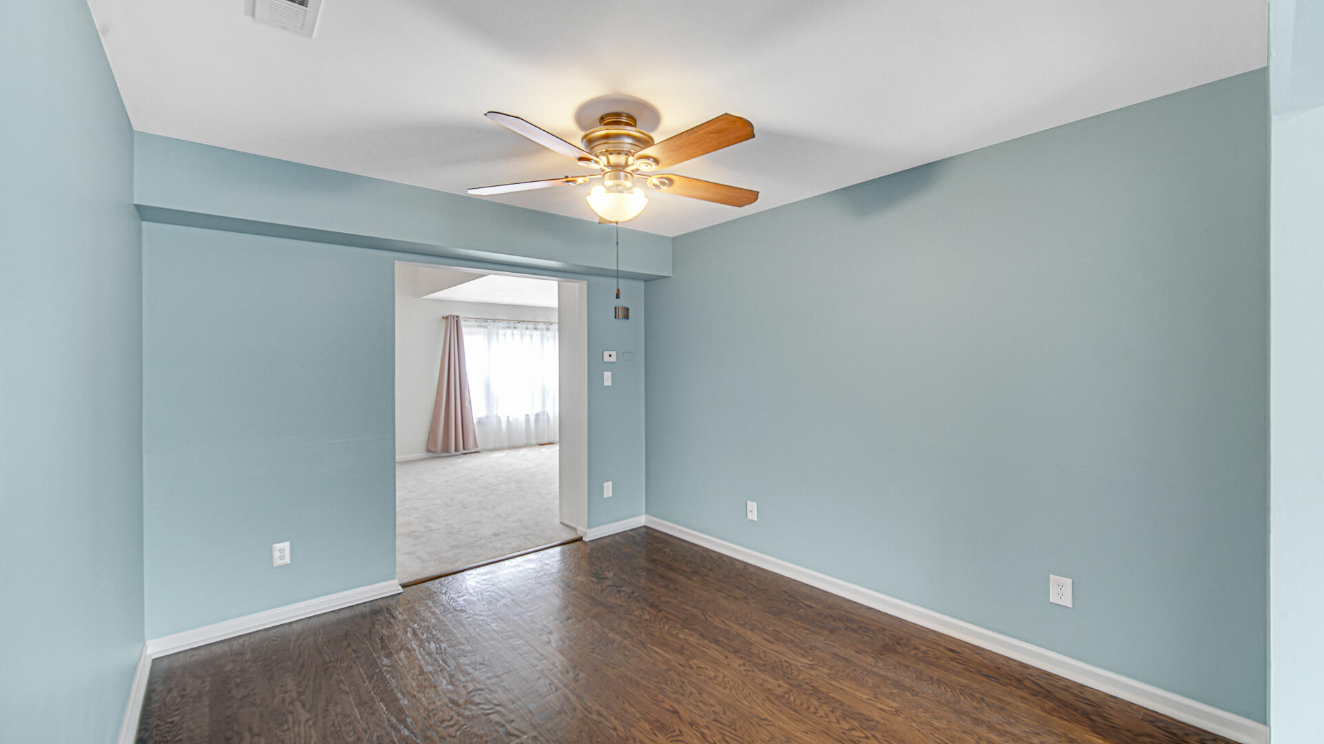771 Kenmare Parkway Crown Point, IN 46307 - Photo 7 of 20 a view of an empty room with window and wooden floor