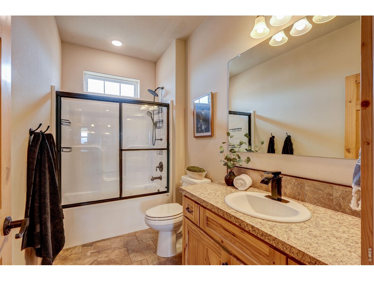 18298 Romar Ranch Road Carr, CO 80612 - Photo 25 of 49 a bathroom with a sink toilet a mirror and shower