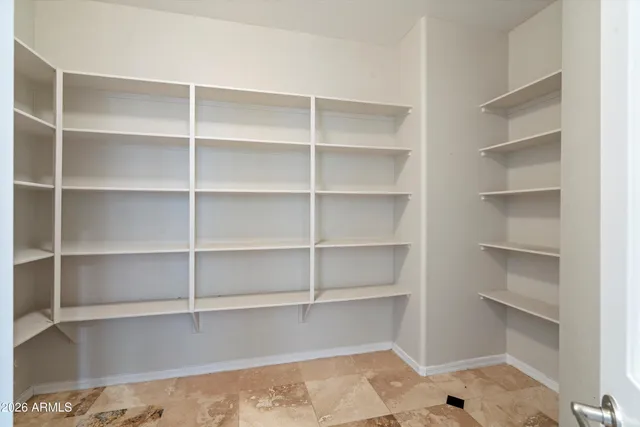 a view of a room with a window and ceiling fan
