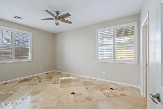 a view of a room with a ceiling fan