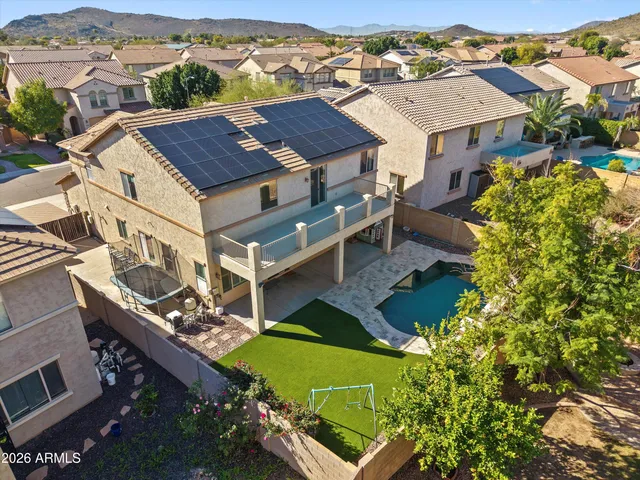 an aerial view of a house with a swimming pool