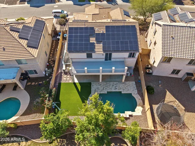 an aerial view of residential houses with outdoor space and parking