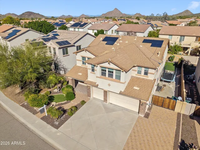 an aerial view of residential houses with a city view