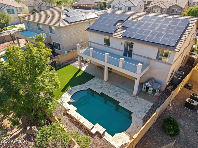 a white house with a large tree in front of it
