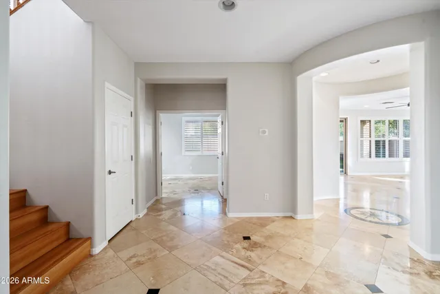 a view of a hallway with wooden floor and cabinet