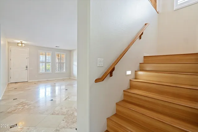 a view of entryway and hall with wooden floor